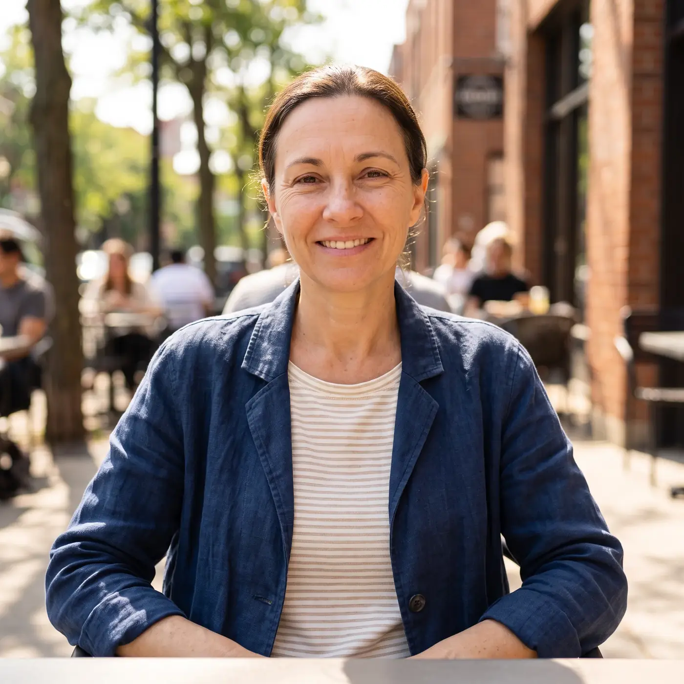 A woman seated outdoors at a cafe, illustrating an everyday buying decision